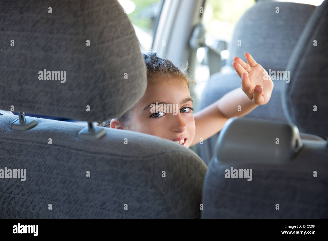 Kind Kinder Mädchen glücklich Gruß Geste Hand in Auto Fahrzeug innen- Stockfoto