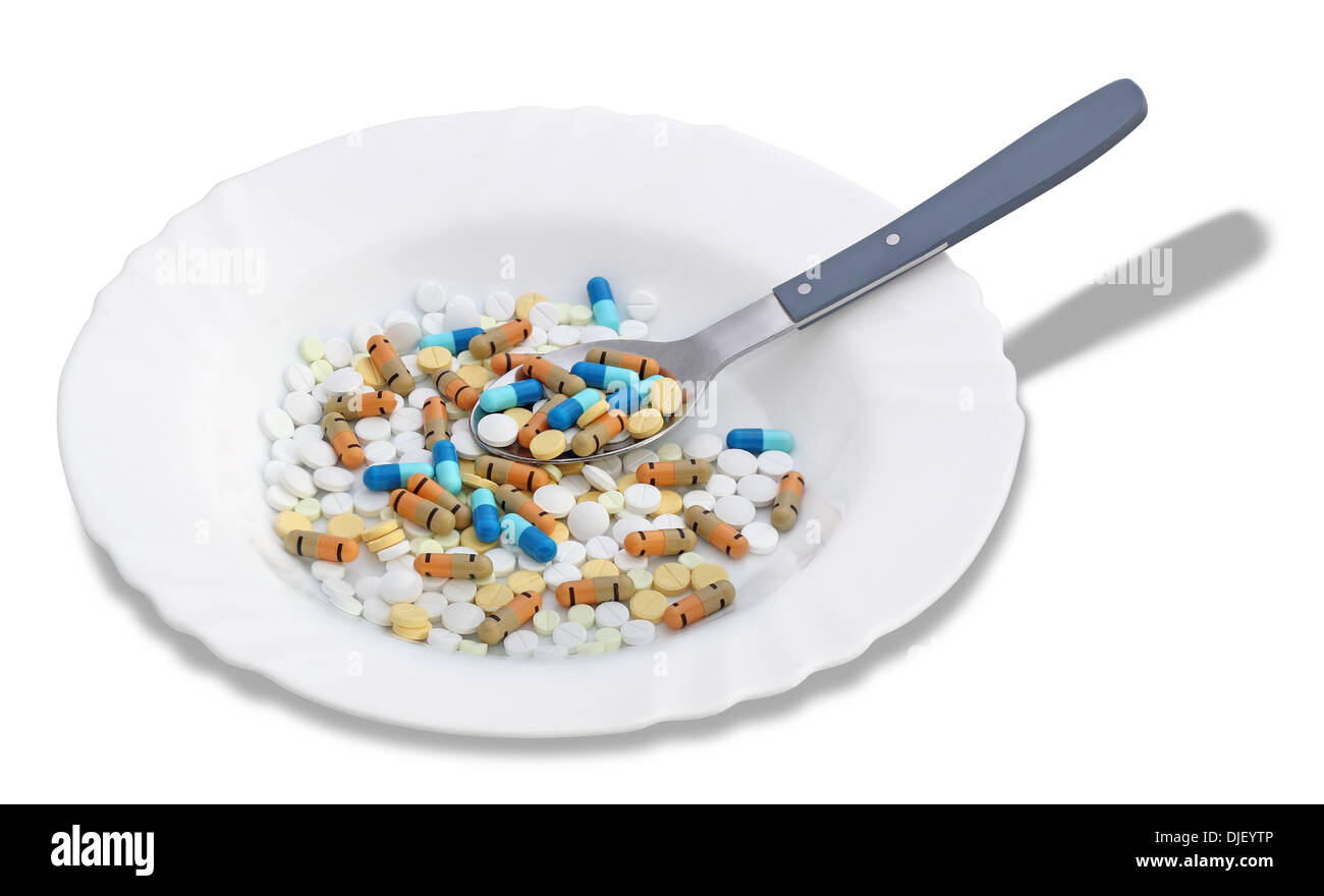 Eine Reihe von bunten Tabletten und Pillen in einer Platte auf einem weißen Hintergrund Stockfoto