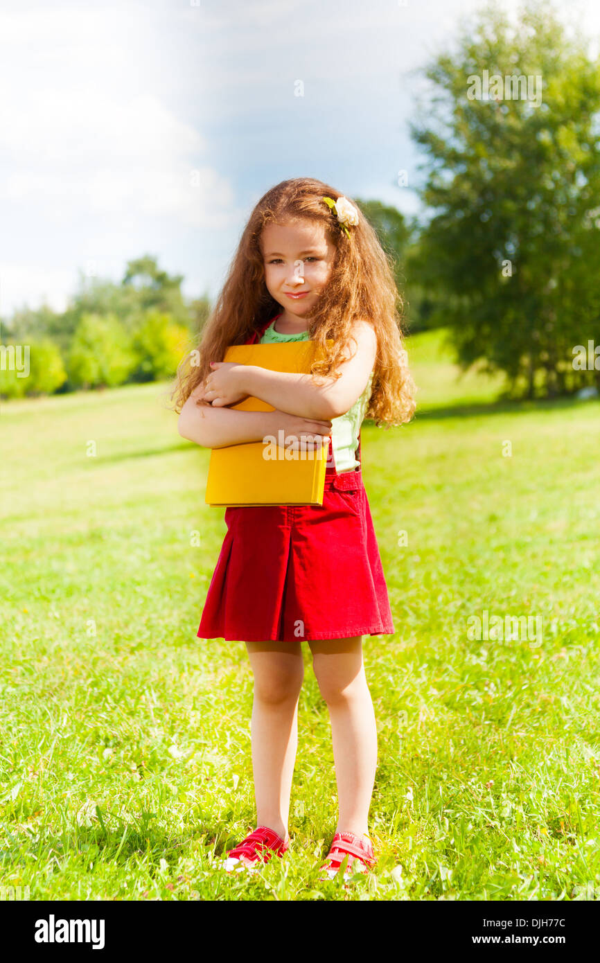 Porträt der schönen 6 Jahre altes Mädchen stehen im Park mit Büchern auf Sommertag Stockfoto