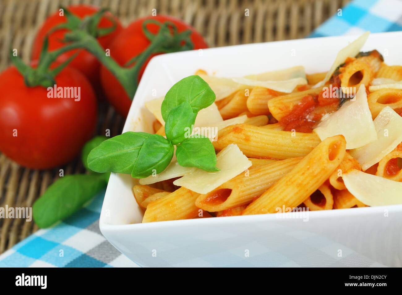 Nudeln mit Tomatensauce, Käse Flocken und frischem Basilikum Stockfoto