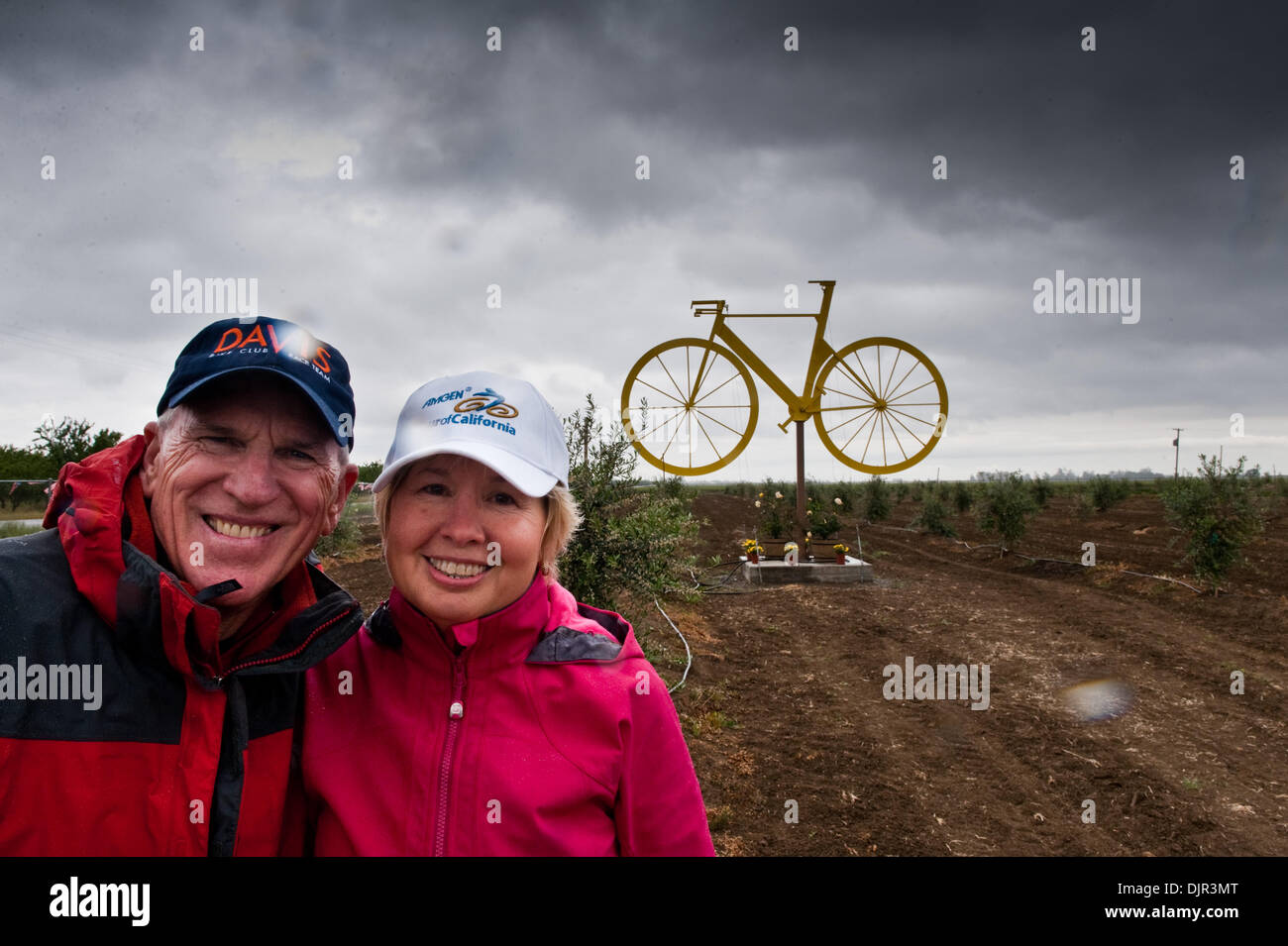 17. Mai 2010 - Winter, Kalifornien, USA - Malcolm und Karen Bond vor ihrer großen gelben Fahrrad, die sie für die Amgen Tour of California gebaut. . Das gelbe Fahrrad ist 15-Füße hoch und 21-Fuß. "Wir wollten eine Tradition zu beginnen, sagt Karen. Und Malcolm wollten den Franzosen zeigen, dass des Amerikaners kann dies auch tun!''. Die große gelben Fahrrad ist in der Mitte ein junger Olivenhain von Stockfoto