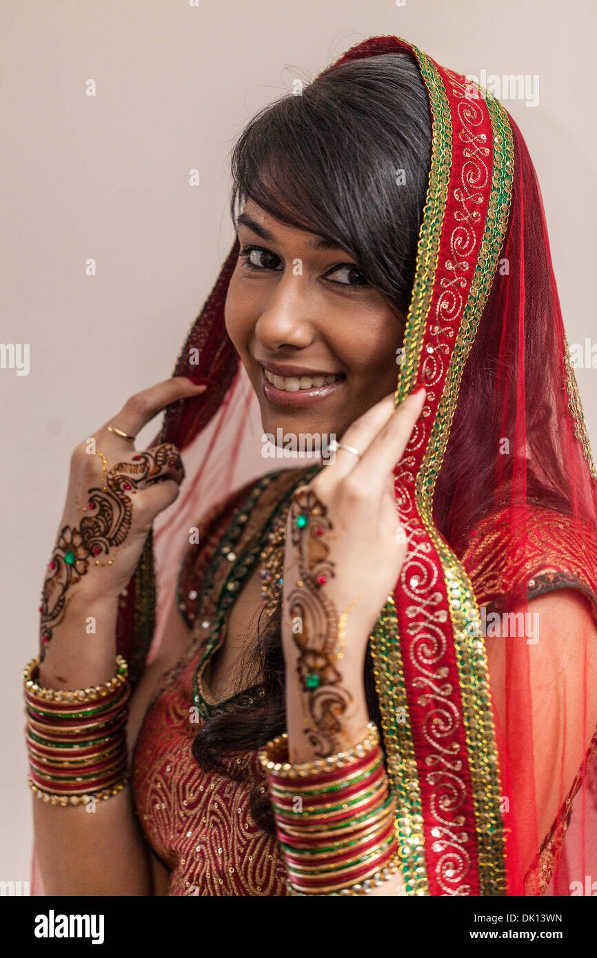 Porträt einer schönen indischen Frau gekleidet in traditioneller Kleidung und Henna-Tattoos auf ihren Händen Stockfoto