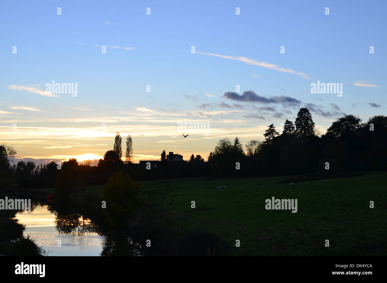 mit Blick auf Wasser blau Himmel Sonnenuntergang weiße Wolken Stockfoto