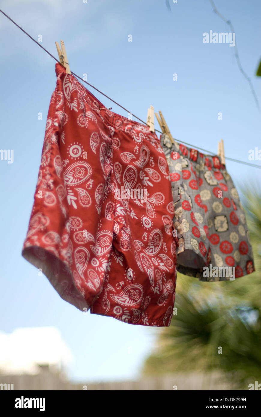 Jungen-Badeanzüge an einer Wäscheleine hängen. Stockfoto