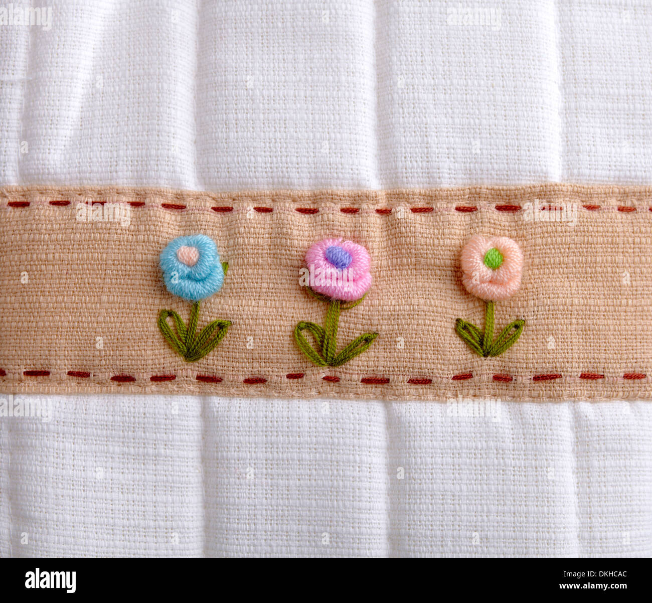 Textur des Tuches mit Handarbeit Blumen Stockfoto