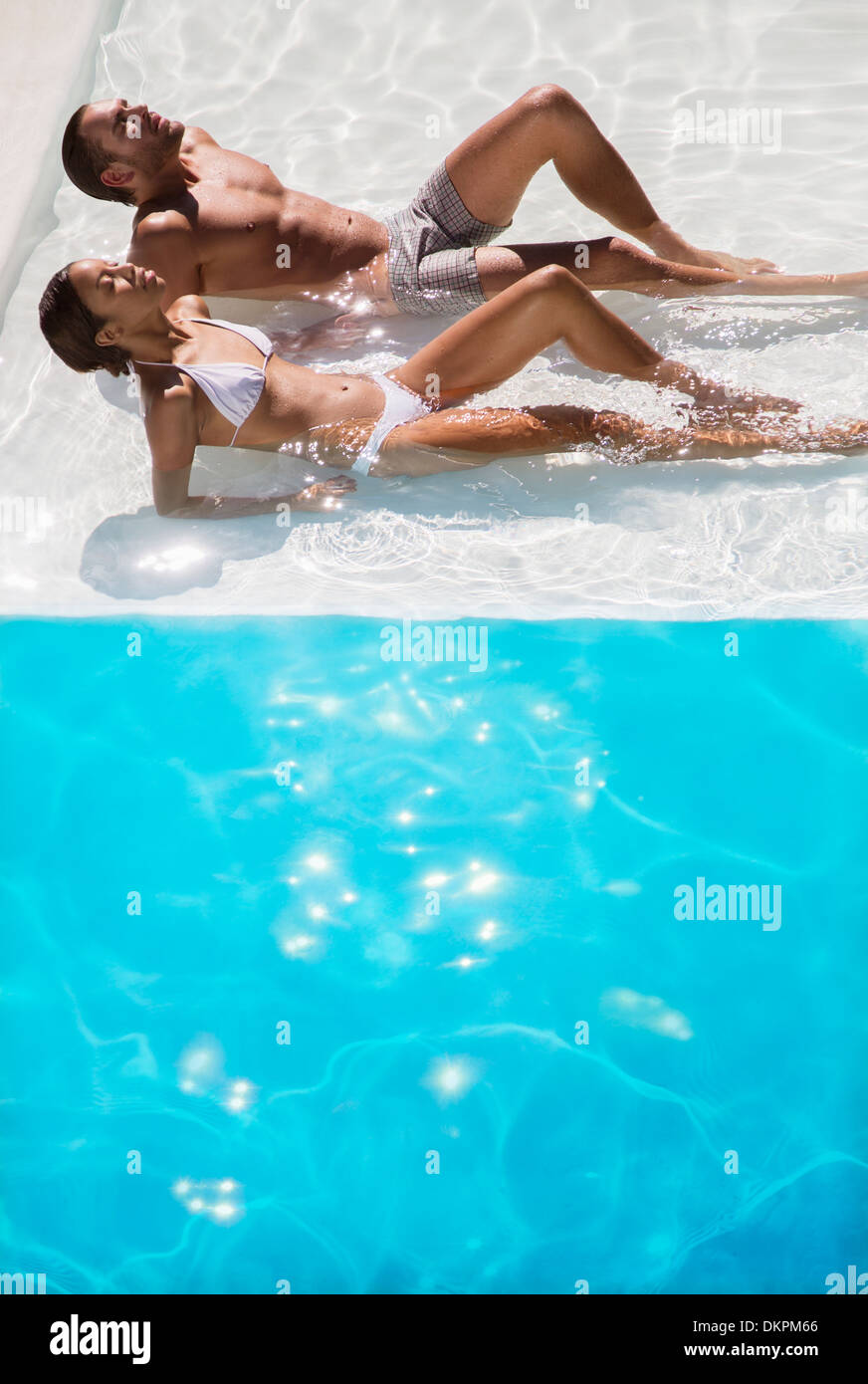 Paar Sonnenbaden im Schwimmbad Stockfoto