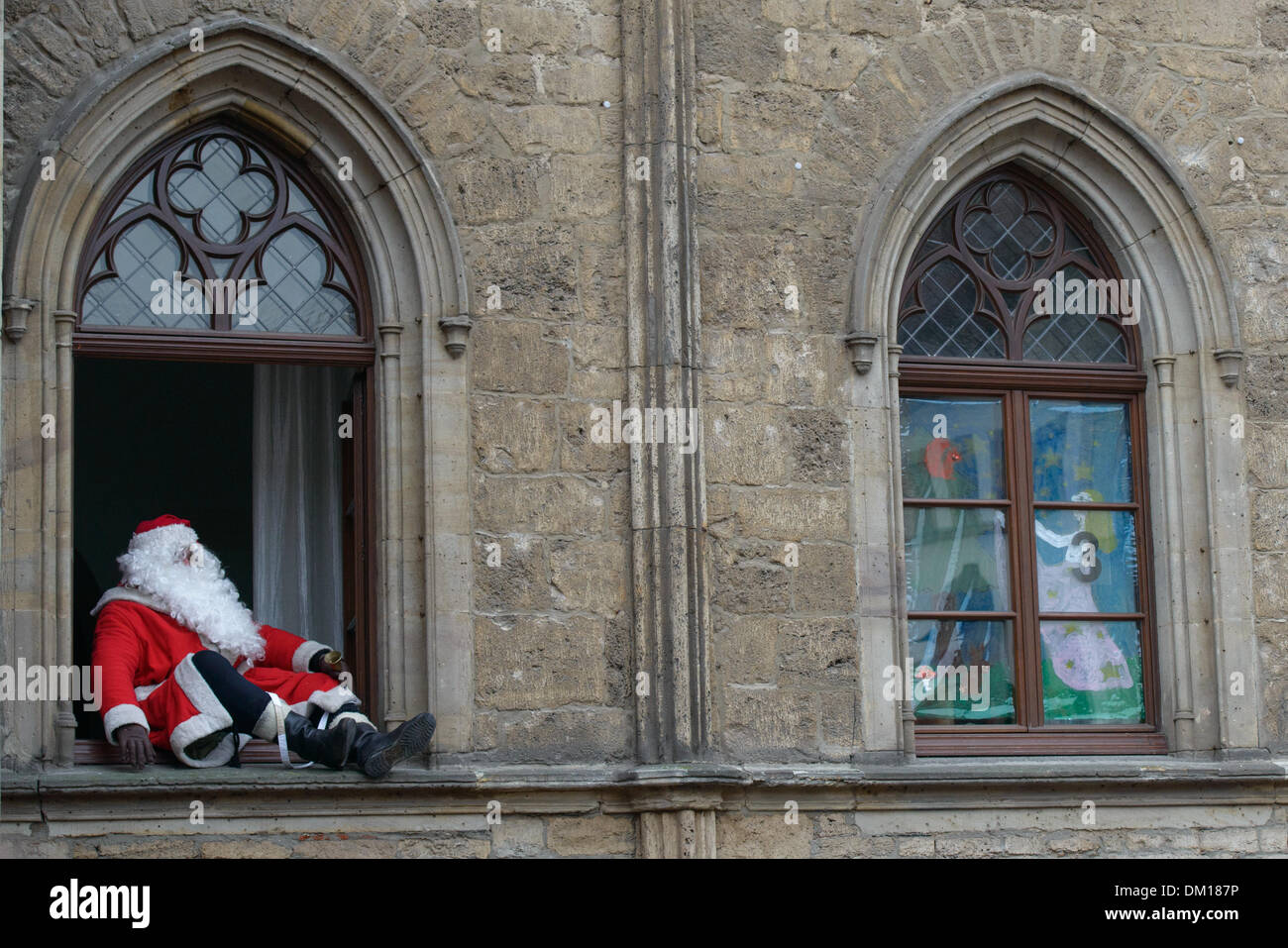 Weimar, Deutschland. 10. Dezember 2013. Ein Mann in ein Weihnachtsmann-Kostüm spricht von einem Fenster in das Rathaus in Weimar, Deutschland, 10. Dezember 2013. Jedes Jahr werden die Fenster des Rathauses in einen riesigen Adventskalender verwandelt. Foto: Candy Welz/ZB/Dpa/Alamy Live News Stockfoto