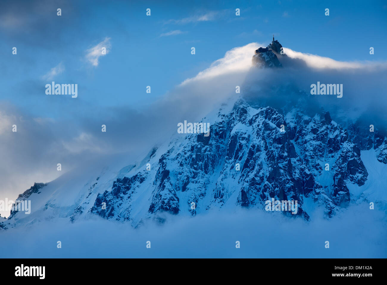 die Aiguille du Midi erscheinen durch die Wolken, Mont Blanc, Les Alpen, Haute-Savoie, Frankreich Stockfoto