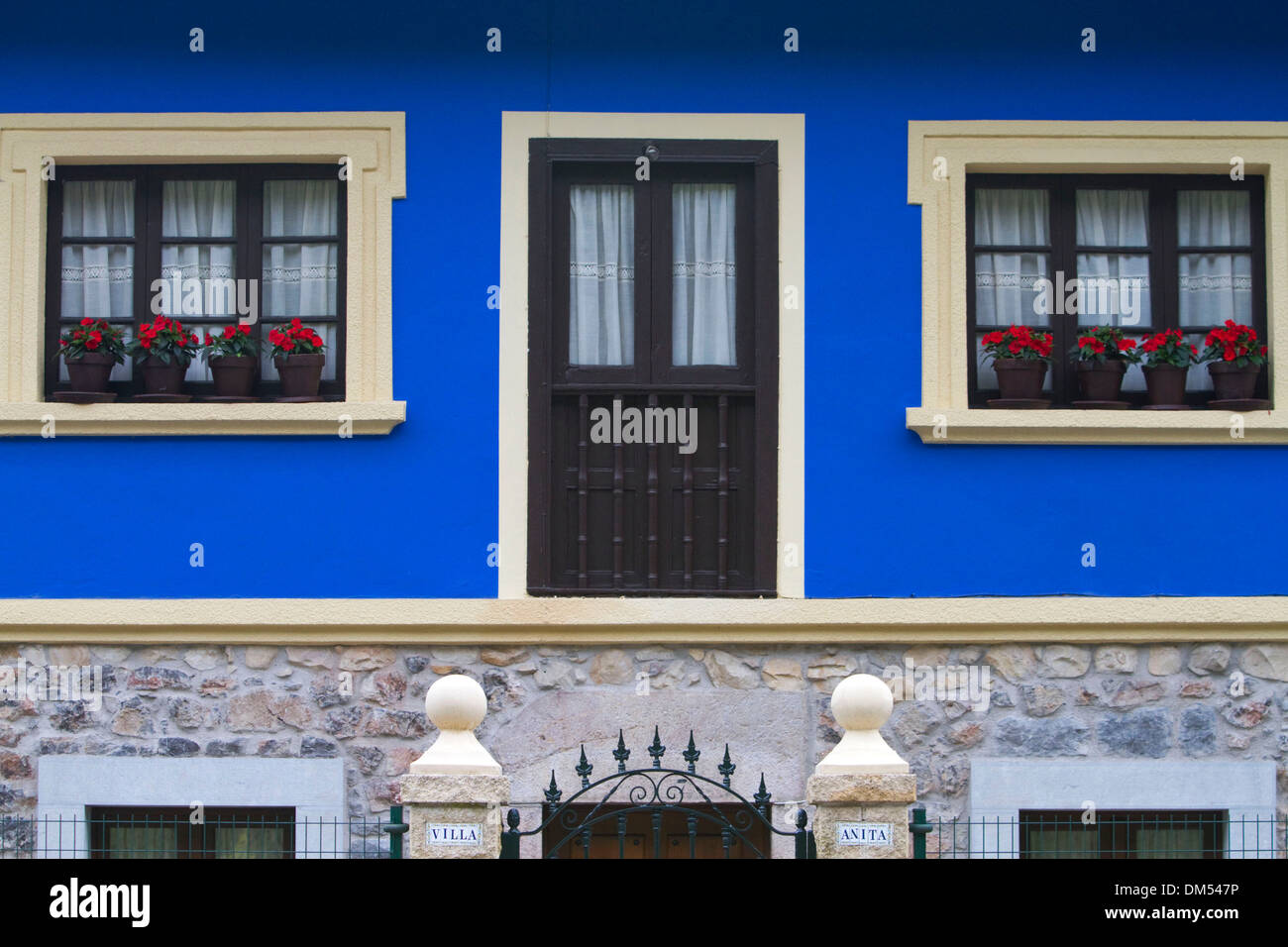 Wohnungsbau mit Blumen in Windows in der Gemeinde von Cangas de Onis in Asturien, Spanien. Stockfoto