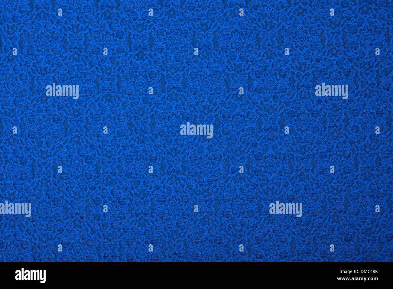 Blauer Stoff mit Blumen, einem Textil-Hintergrund. Stockfoto