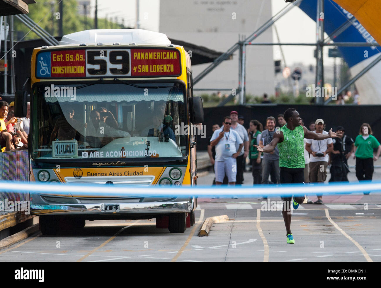 Buenos Aires, Argentinien. 14. Dezember 2013. Die jamaikanische Rekordhalter Usain Bolt (R) läuft gegen einen Bus, in einem Rennen in der 9 de Julio "Avenue, in Buenos Aires, Argentinien am 14. Dezember 2013. Bolzen verschiedene Aktivitäten durchgeführt, während seines Besuchs in Argentinien mit einem Vortrag über Führung, sportliche Kliniken für Kinder in Armut und ein Rennen von 80 Metern gegen einen Bus in der 9 de Julio "Avenue. Bildnachweis: Martin Zabala/Xinhua/Alamy Live-Nachrichten Stockfoto