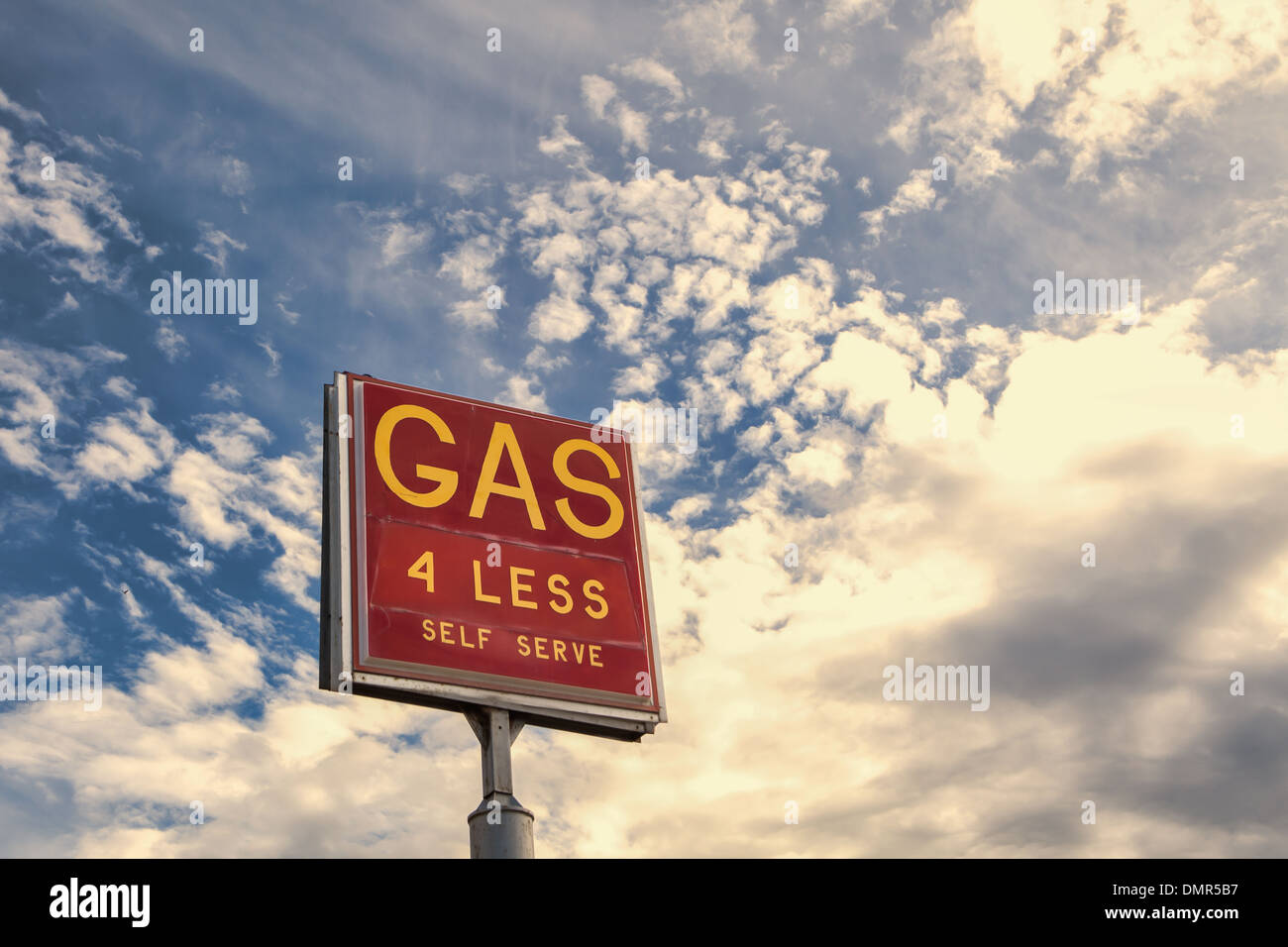 Oldtimer Tankstelle melden Werbung billiges Gas mit einem blauen Himmel und Wolken. Stockfoto