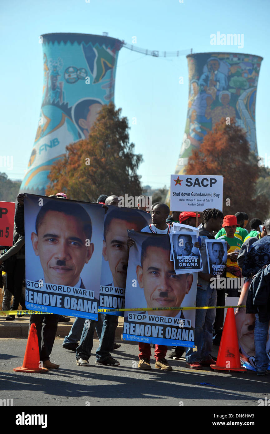 Anti-Obama-Demonstranten halten Plakate vor dem Wasser erhebt sich in Soweto, Südafrika. Stockfoto