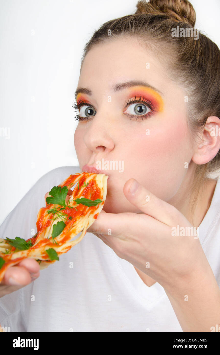 Frau im bunten Make-up mit Spaghetti in den Mund, den sie tat Stockfoto