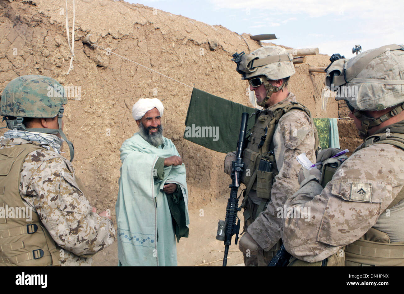 US-Marines sprechen mit einem afghanischen Mann während Patrouillen 20. Dezember 2013 in Boldak, Provinz Helmand, Afghanistan. Stockfoto
