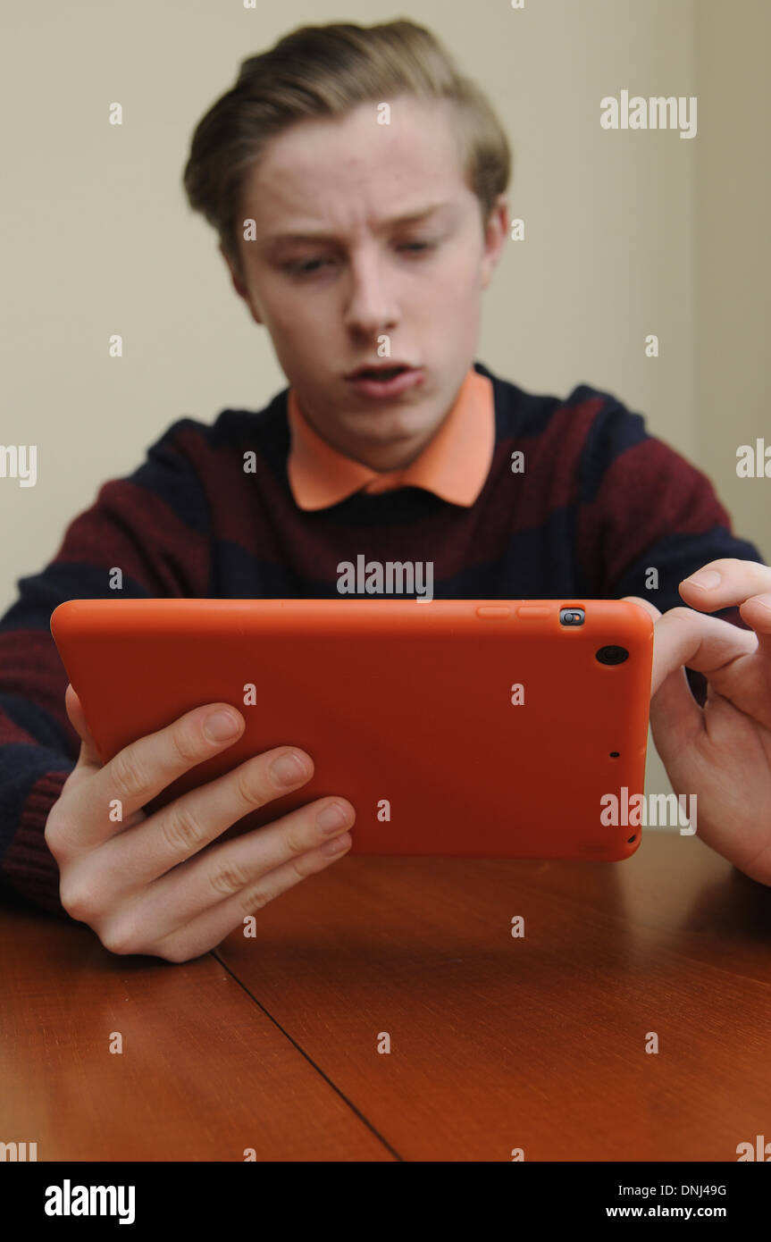 16 jähriger Junge mit einem Tabletcomputer Stockfoto