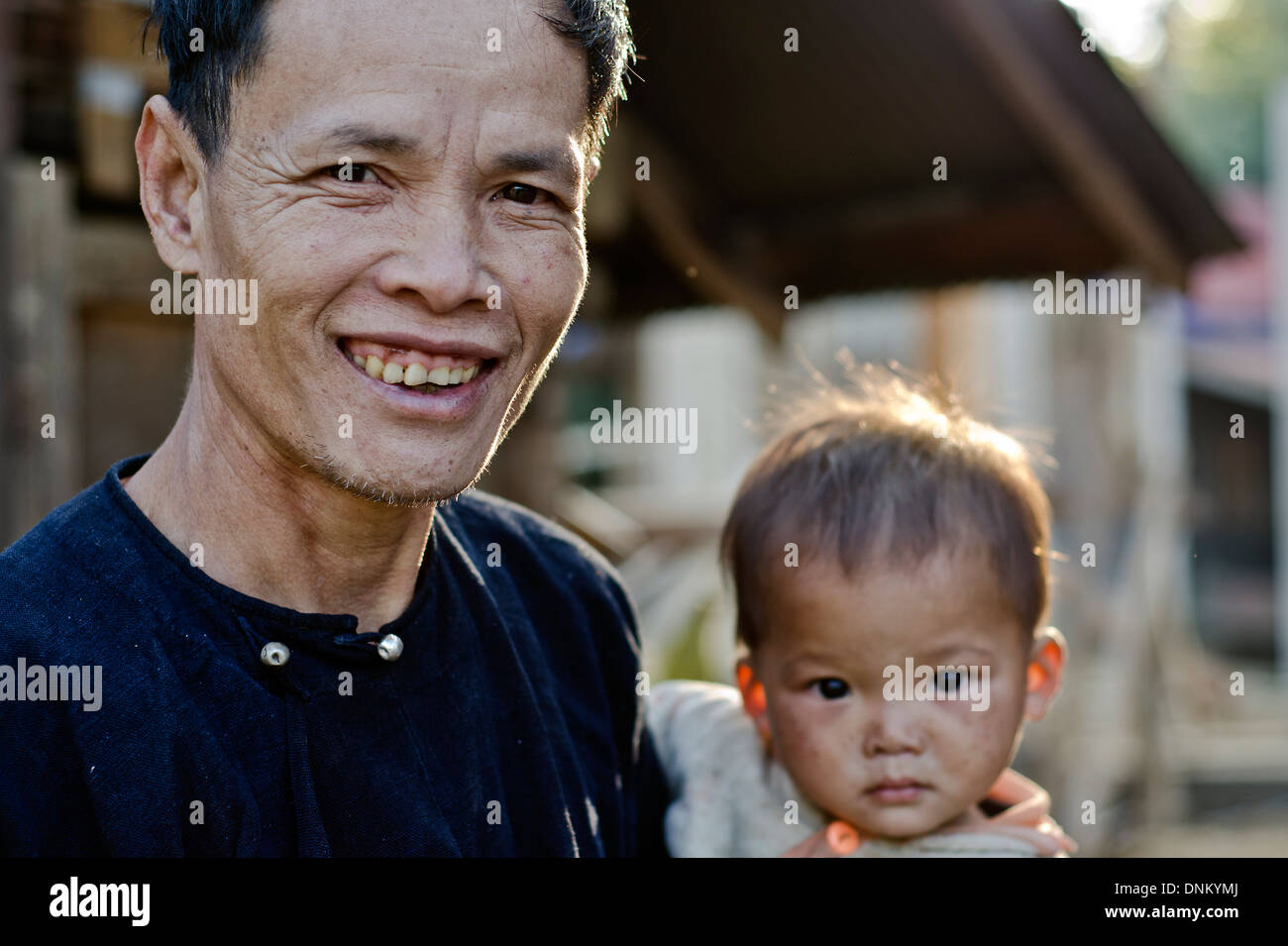 Laten Sie Stamm Mann mit Baby, Pakha Dorf, Muang Sing, Laos Stockfoto