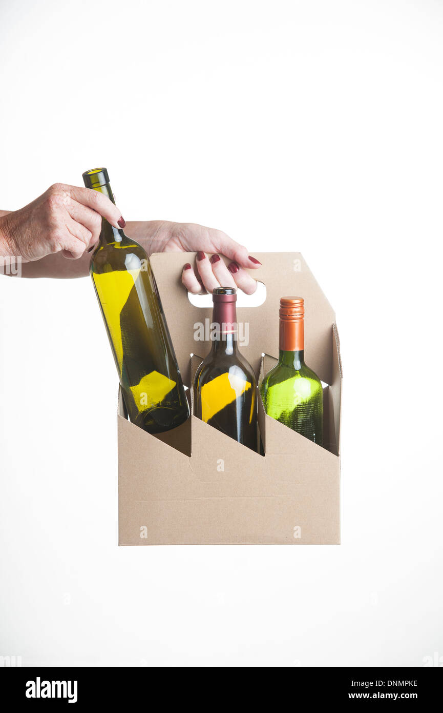Karton Weinflasche Träger Womans Hand Platzierung Glasflasche in den Schlitz Stockfoto