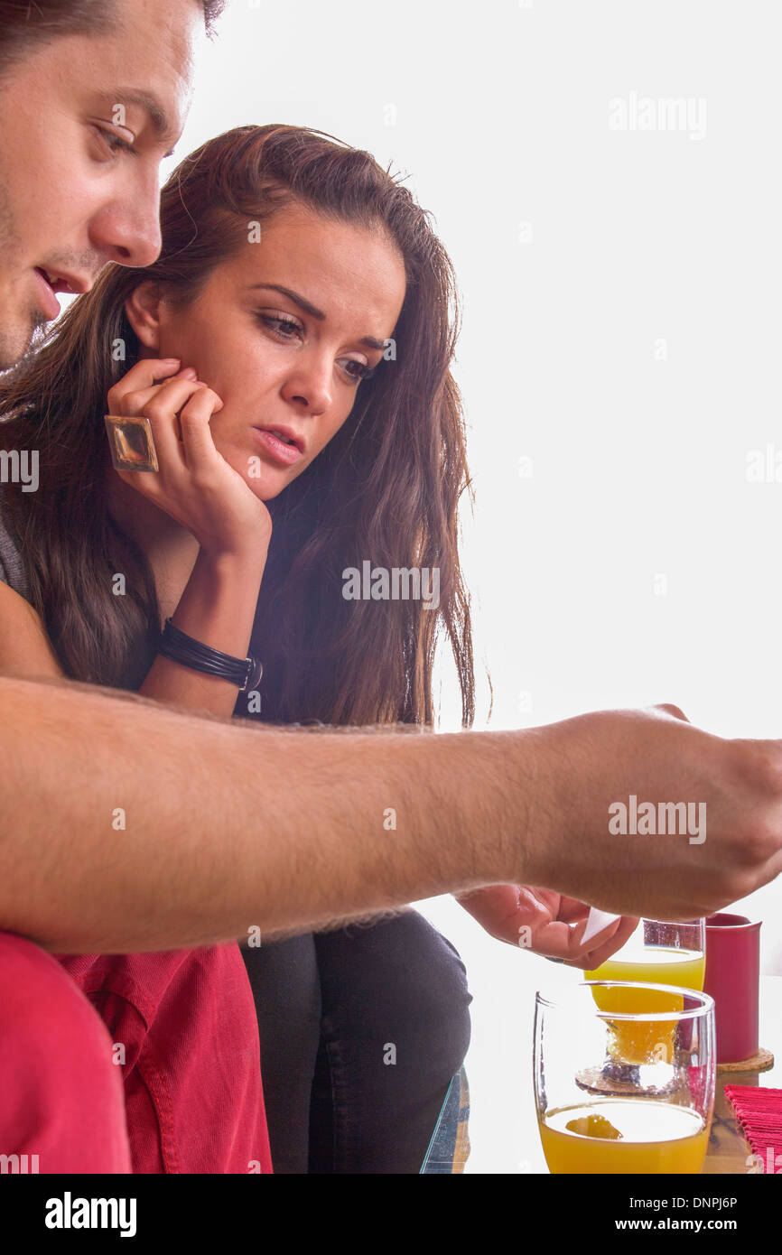 Mann zeigt Frau Dokument beim Sitzen Stockfoto