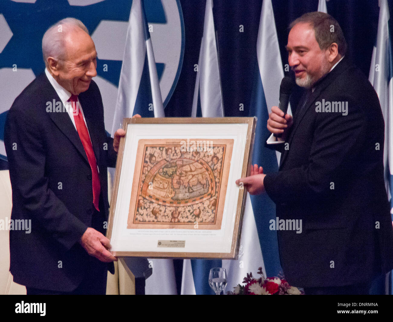 Jerusalem, Israel. 5. Januar 2014. FM, Avigdor Lieberman (R), begrüßt israelischen Präsidenten Shimon Peres (L), und stellt ihn mit einer Karte der Welt; "Du bist hier, am Südpol, und ich bin am Nordpol. Möglichst weit voneinander entfernt, wie möglich, aber wir beide das gleiche wollen ". Jerusalem, Israel. 5. Januar 2014.  Staatspräsident Peres eröffnet der Botschafterkonferenz für Leiter der israelischen diplomatischen Vertretungen weltweit neben Außenminister Lieberman im Ministerium für auswärtige Angelegenheiten. Bildnachweis: Nir Alon/Alamy Live-Nachrichten Stockfoto