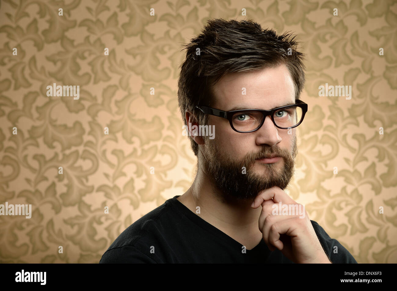 Porträt des jungen Mann mit Bart und Brille über Retro-Hintergrund Stockfoto
