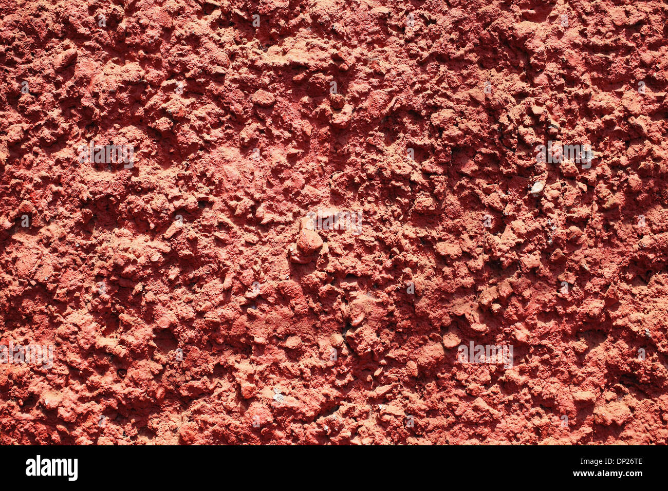 Textur des roten holprigen Betonmauer hautnah Stockfoto