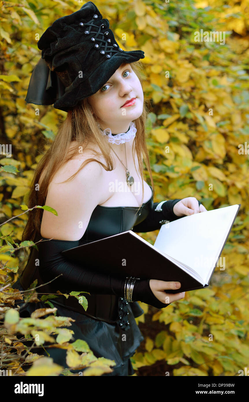Cos-Player mit einem Buch im Herbst park Stockfoto