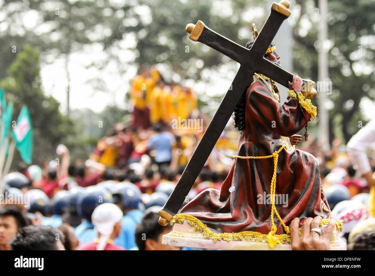 Metro Manila, Philippinen-Januar 9, 2014: Eine Replik Statue des schwarzen Nazareners während der Prozession. Tausende von philippinischen katholischen Gläubigen versammelten sich in der Hauptstadt des Landes für eines der weltweit größten religiösen Umzügen eine schwarze Statue von Jesus Christus zu Ehren sie glauben Wunderkräfte hat, wem sie die Black Nazarene genannt. Bildnachweis: Herman Lumanog/Alamy Live-Nachrichten Stockfoto