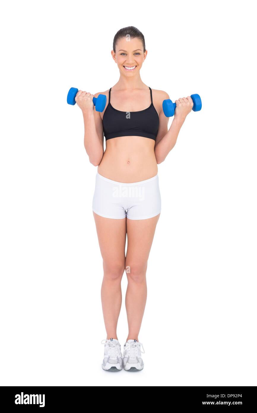 Lächelnde Fit Frau Workout mit Hanteln Stockfoto
