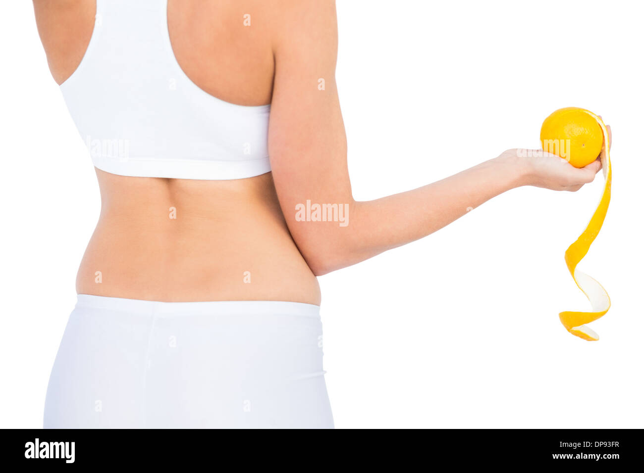 Rückansicht des Fit Frau Sportswear halten geschälte orange Stockfoto