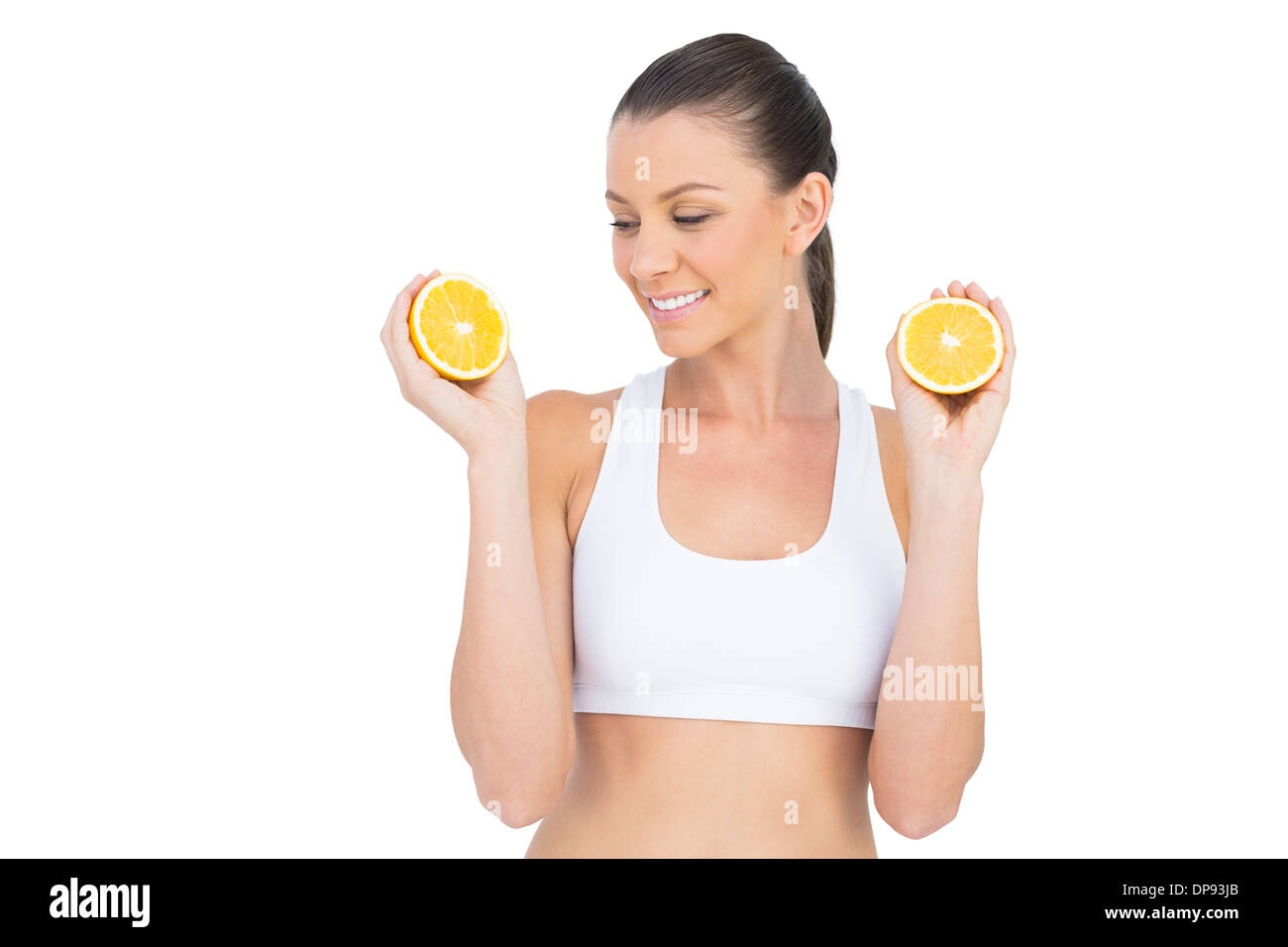 Fit Frau mit Scheiben von orange Stockfoto