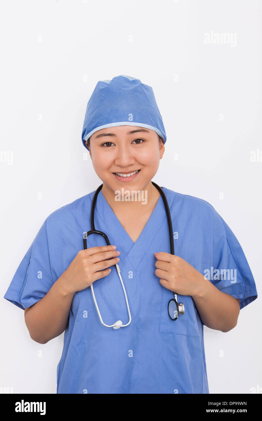 Porträt von glücklich Ärztin mit Stethoskop um Hals vor weißem Hintergrund Stockfoto