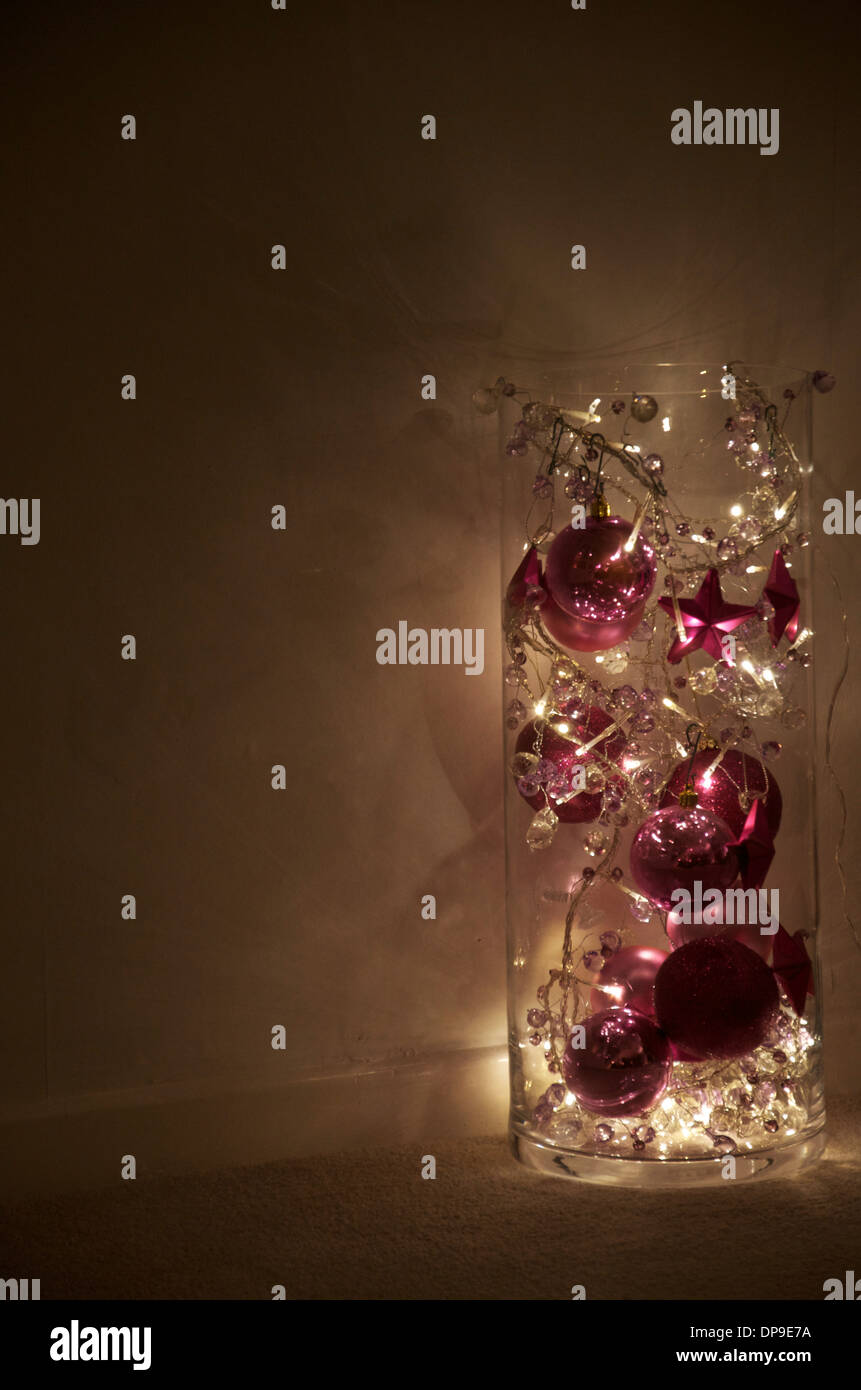 Weihnachtsbeleuchtung und Ornamente in einer Glasröhre. Stockfoto
