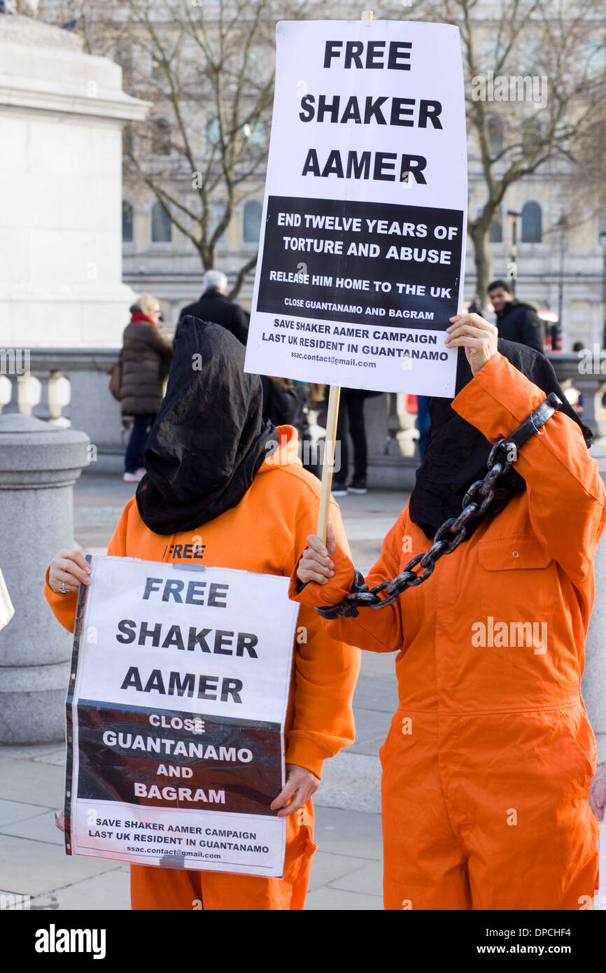 Demonstranten in Orange passt zum zwölften Jahrestag der Eröffnung des extralegale Gefangenenlager in Guantánamo Bay Stockfoto