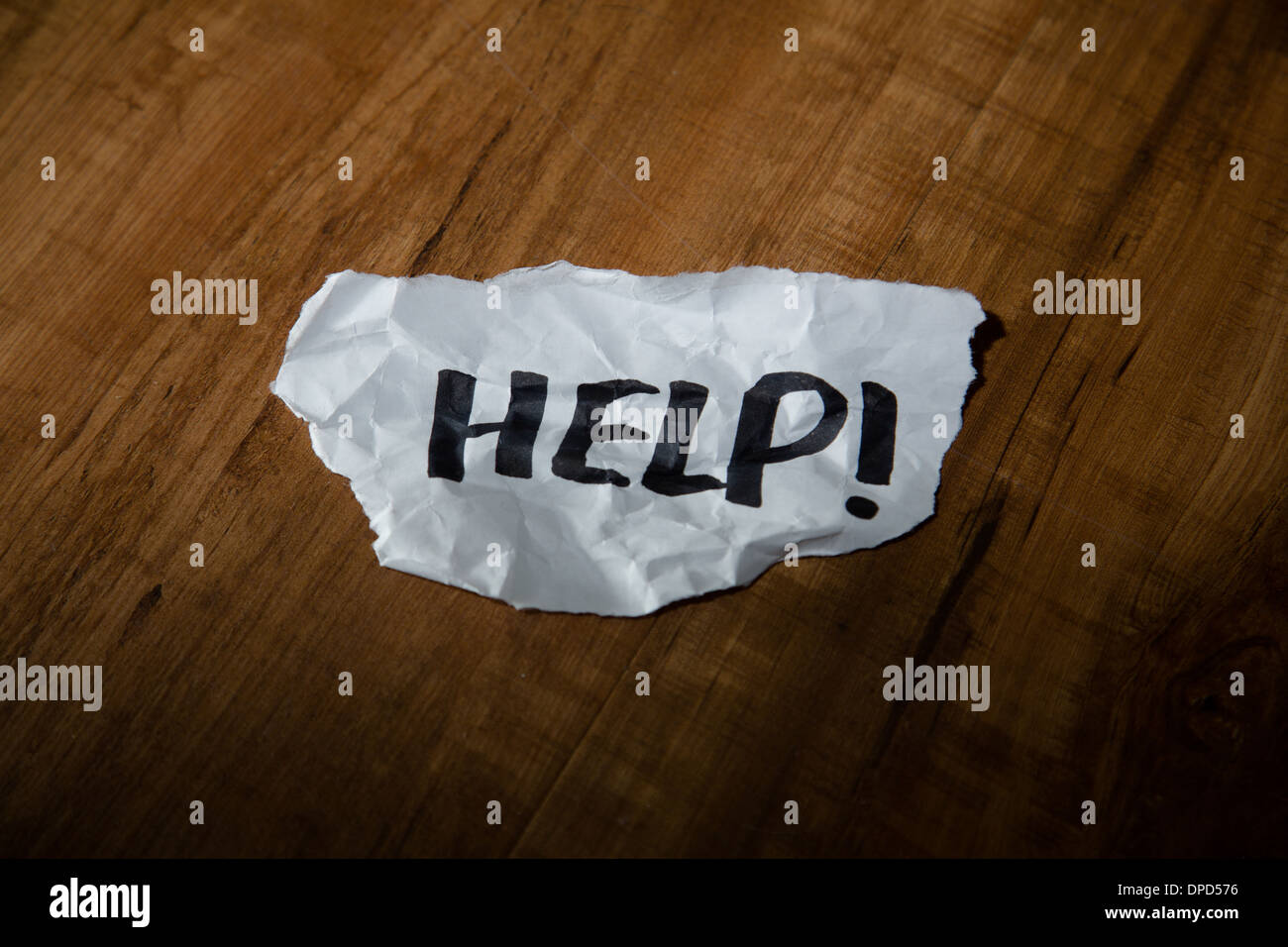 Ein Hilferuf - zerknittert "Hilfe" Zeichen auf dem Boden Stockfoto