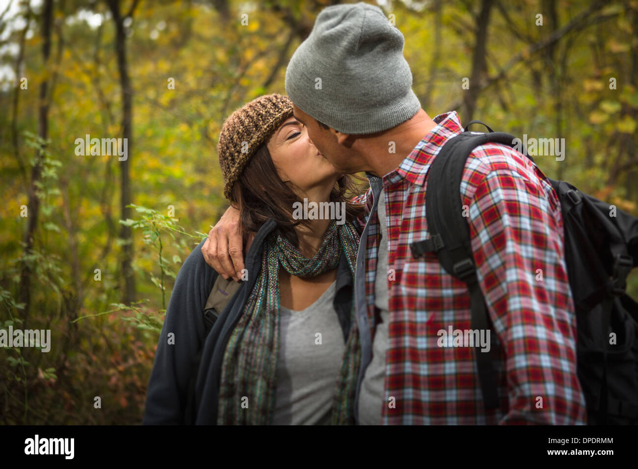 Mature couple kissing in forest -Fotos und -Bildmaterial in hoher Auflösung  Bild