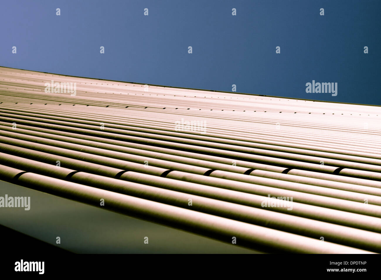 Abstrakte kreative getönten Foto von industriellen Metallrohre über wolkenloser blauer Himmel, einfachen Hintergrund mit Textfreiraum. Stockfoto