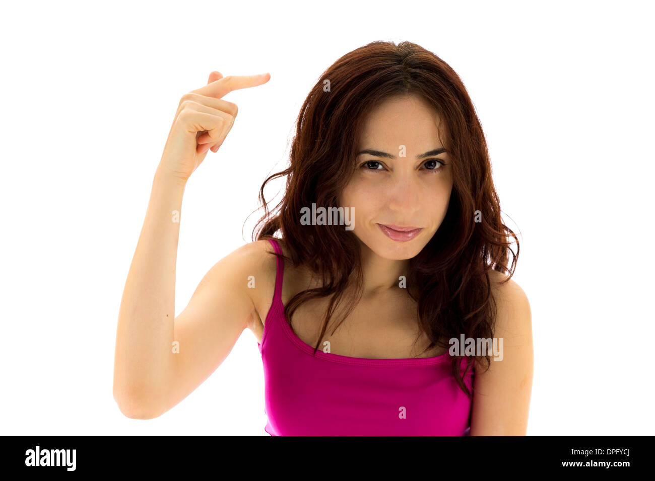 Junge Frau zeigt eine Geste, die darauf hinweist, dass jemand verrückt ist. (Serie mit dem gleichen Modell verfügbar) Stockfoto