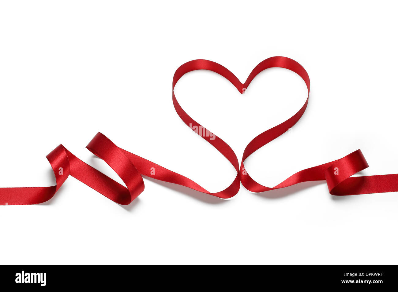 Red Ribbon in Herzform, Valentines Konzept. Stockfoto