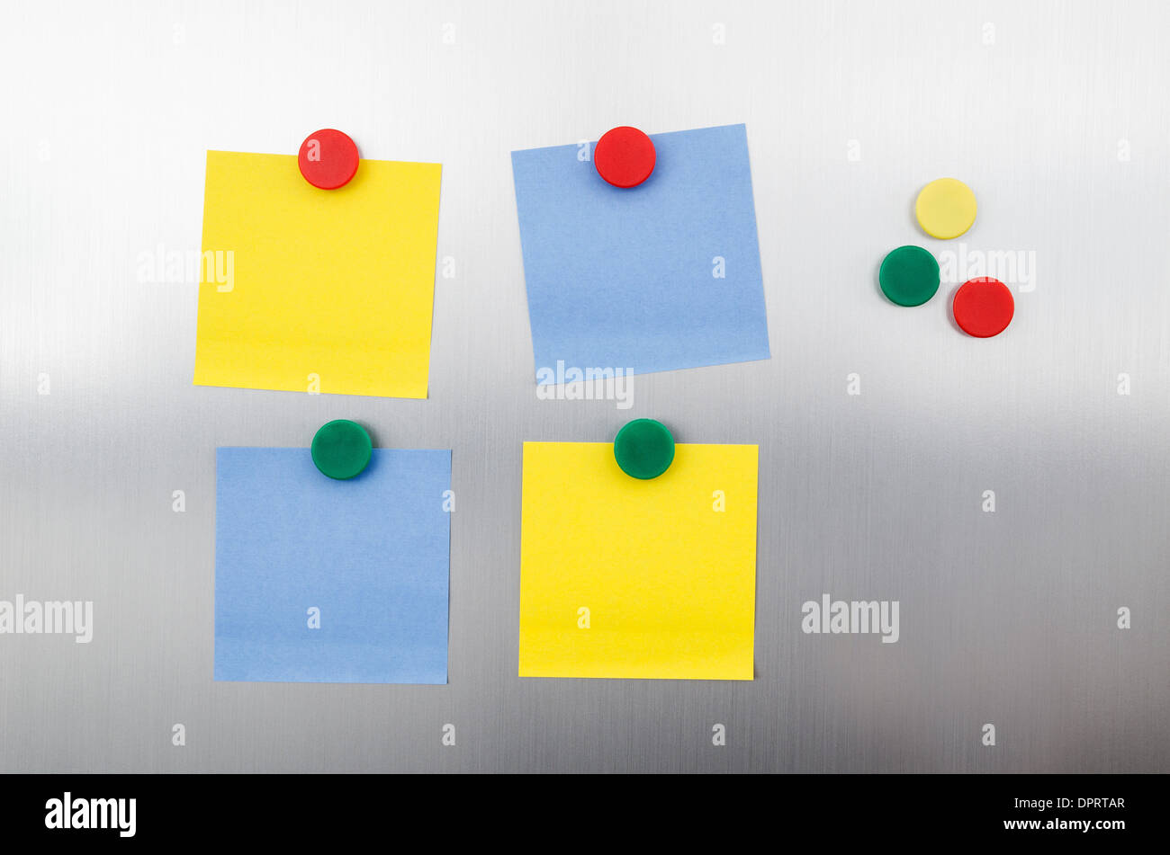 Farbige Notizen und Magnete auf Inox metallic Kühlschrank Stockfoto