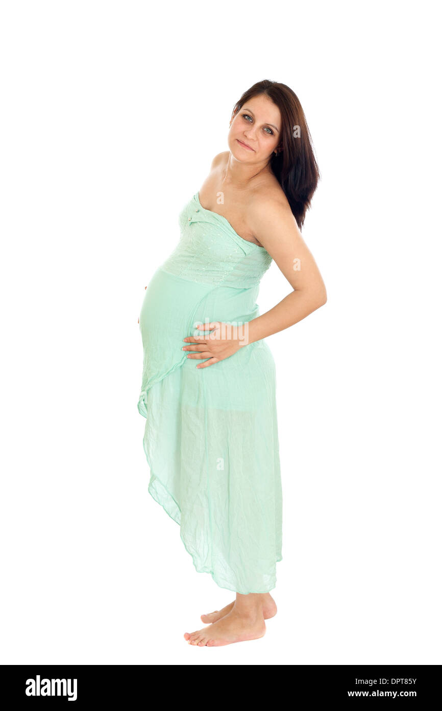 Porträt von glücklich schwangere Frau mit grünem Kleid hält ihren Bauch. Isoliert auf weißem Hintergrund Stockfoto