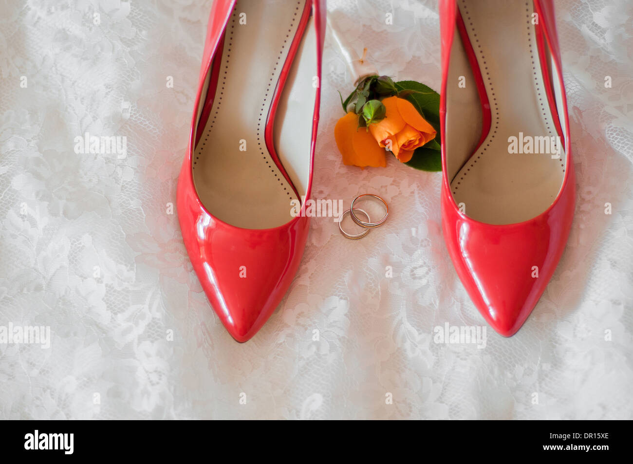 rote Schuhe der Braut, Trauringe und Knopfloch auf ein Brautkleid  Stockfotografie - Alamy