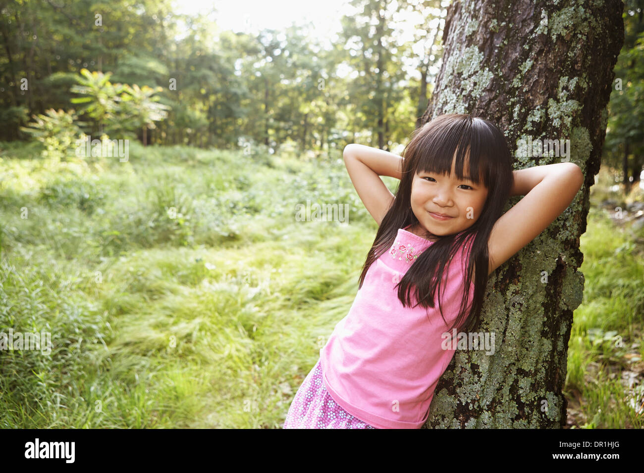 Mädchen im freien Baum gelehnt Stockfoto