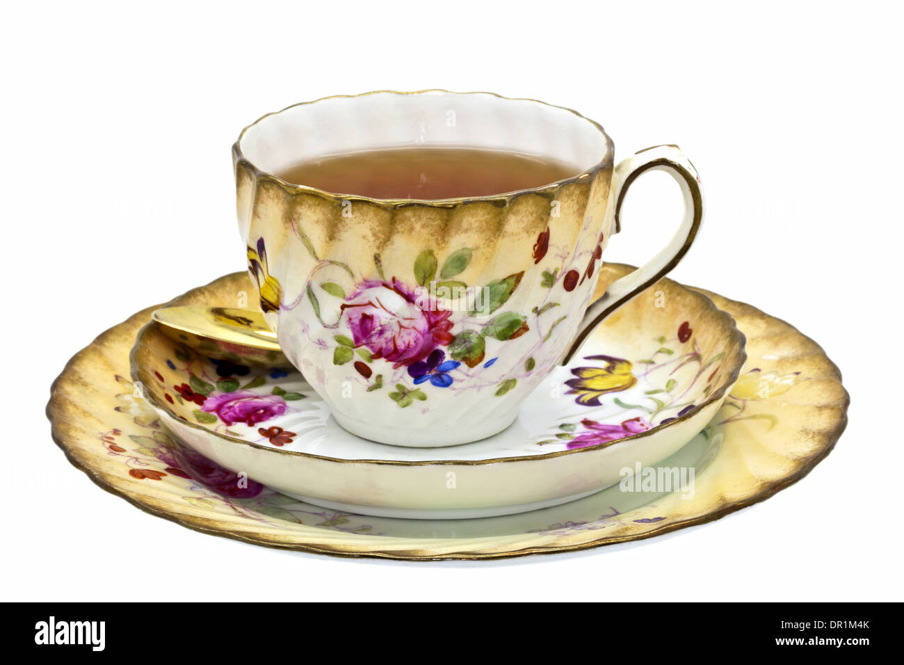 Tee in eine antike China-Tasse mit Untertasse und Dessert Teller. Stockfoto