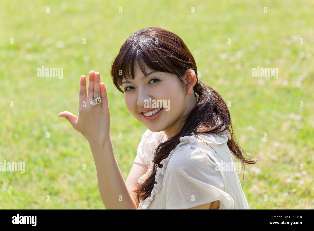 Junge Frau mit Ring aus der Blume Stockfoto