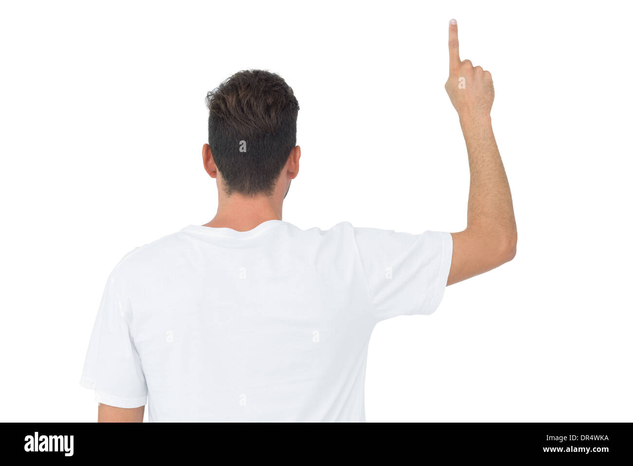 Rückansicht eines jungen Mannes nach oben zeigend Stockfoto