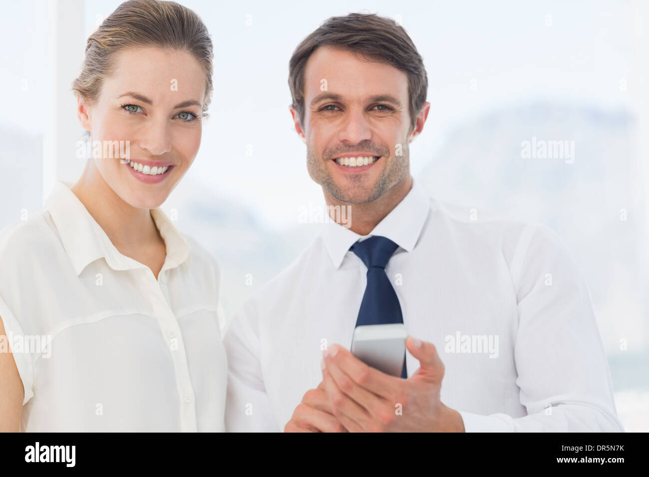 Elegant gekleidet Kollegen mit einem Mobiltelefon Stockfoto