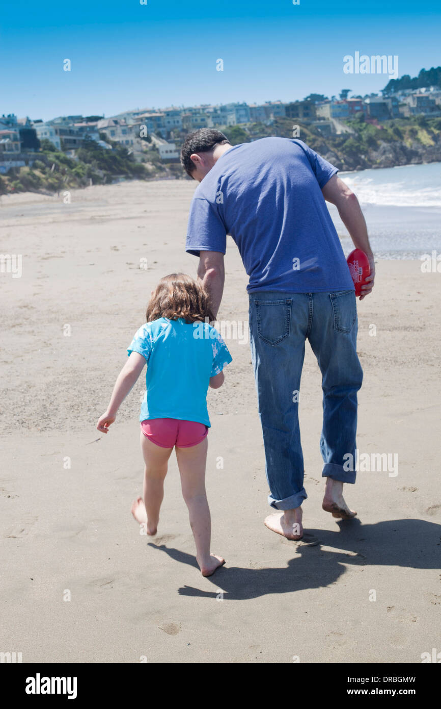 Rückansicht von Vater und Tochter am Strand Stockfoto
