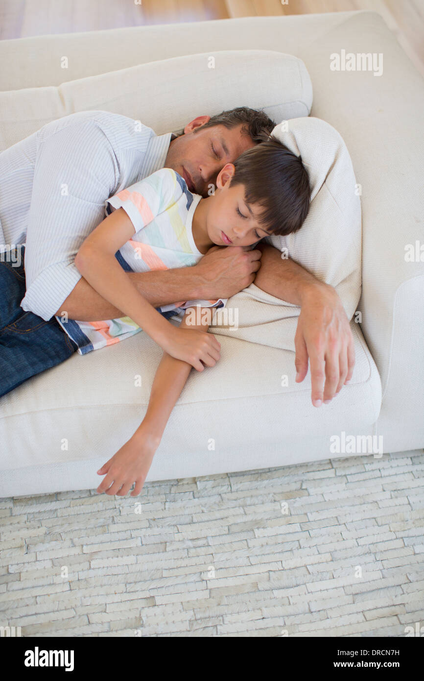 Vater und Sohn Nickerchen auf dem Sofa im Wohnzimmer Stockfoto