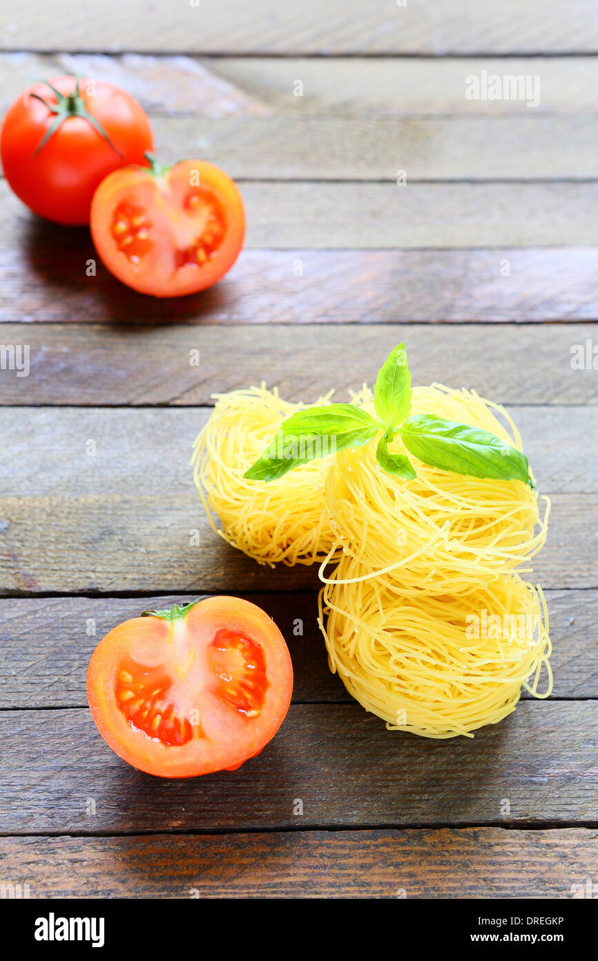 Pasta und frischen Tomaten auf hölzernen Oberflächen, Essen Nahaufnahme Stockfoto